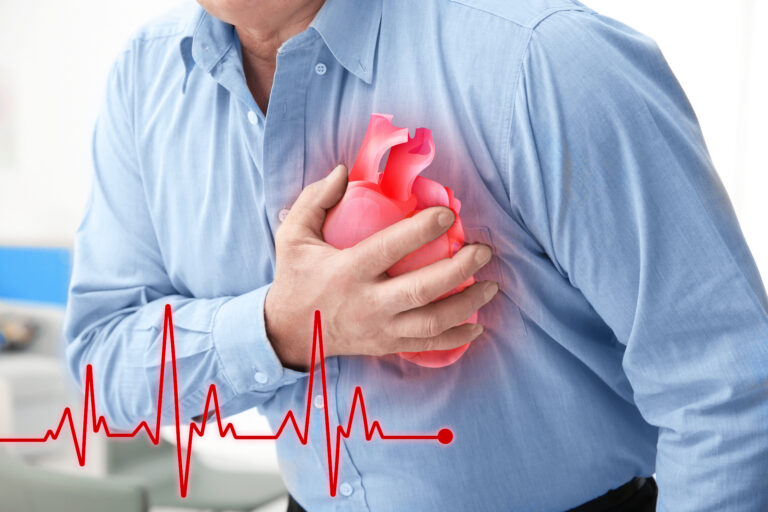 Man with chest pain suffering from heart attack in office